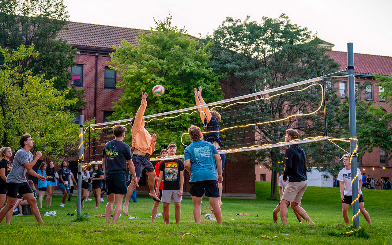 students playing sand volleyball
